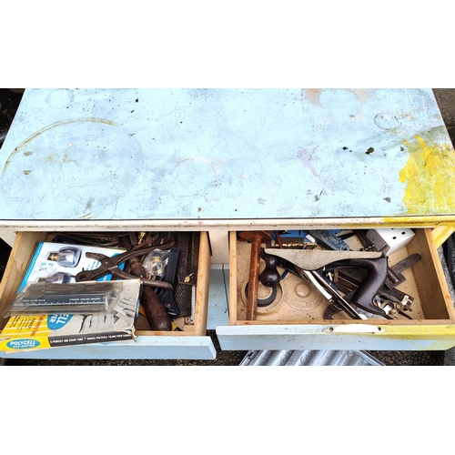 194 - A vintage work bench with attached clamps, vintage cupboard with tools, chisels etc