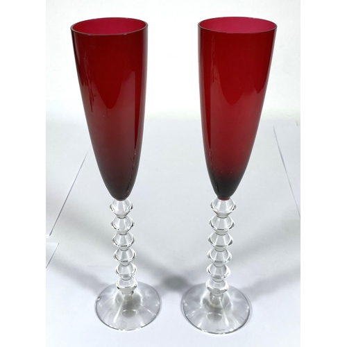 412 - BACCARAT: a set of of two Vega Flutissimo crystal champagne flutes, etched signature to bases, red a... 