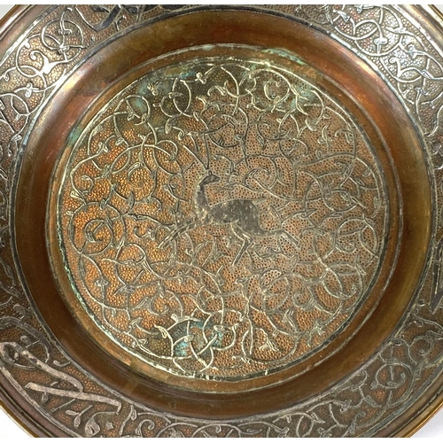 425 - A 19th century Middle Eastern copper dish overlaid with silver, 21cm: a white metal dish (tests as s... 