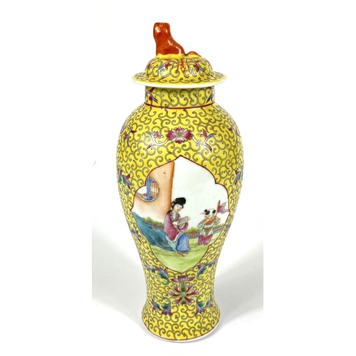 426 - A Chinese covered baluster shaped vase, two enamelled reserves on yellow ground, 27cm