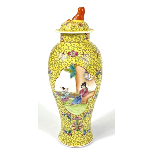 426 - A Chinese covered baluster shaped vase, two enamelled reserves on yellow ground, 27cm