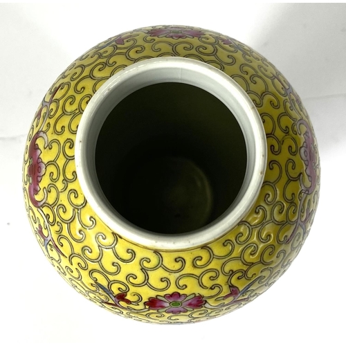 426 - A Chinese covered baluster shaped vase, two enamelled reserves on yellow ground, 27cm