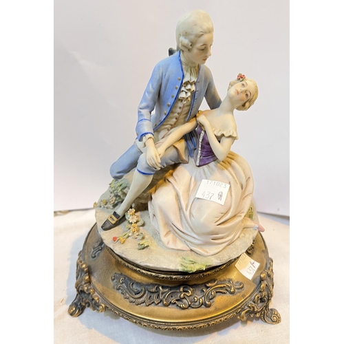 437A - An Italian Triade Benacchio Capodimonte group of 18th century lady and gentleman on metal base