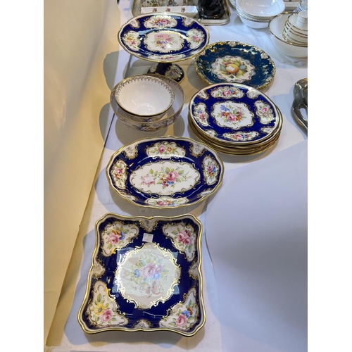 453 - A 19th century style Hammersley 7 piece dessert service with polychrome panels against a blue/ gilt ... 