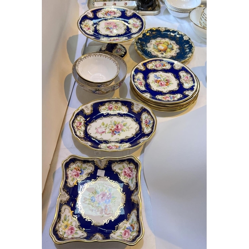 453 - A 19th century style Hammersley 7 piece dessert service with polychrome panels against a blue/ gilt ... 