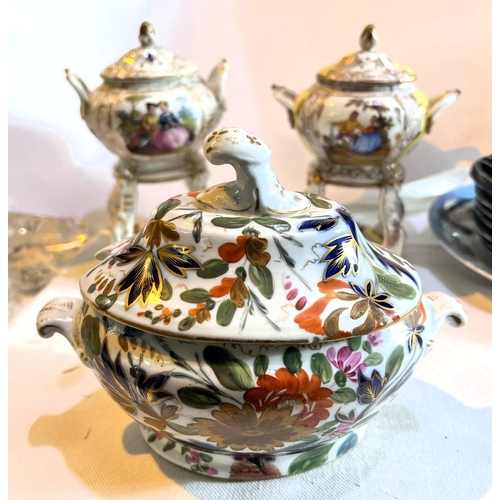 458 - Two Meissen miniature ceramic tea burners with decorated panels, gilt highlights and a similar lidde... 