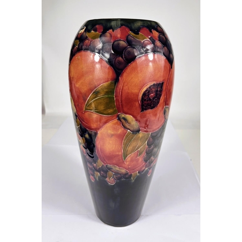 490 - William Moorcroft large Pomegranate vase on dark blue ground, ht. 33cm (bearing restoration)