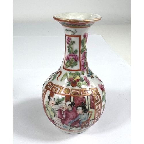 519 - A 19th century famille rose bottle shaped vase with flaring rim, finely decorated with panels of bir... 