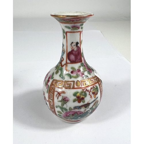 519 - A 19th century famille rose bottle shaped vase with flaring rim, finely decorated with panels of bir... 