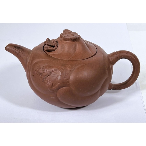 535B - An early 20th century Chinese Yixing teapot with relief decoration and pop out dragon to lid