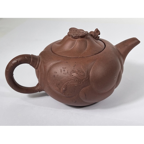 535B - An early 20th century Chinese Yixing teapot with relief decoration and pop out dragon to lid