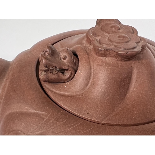 535B - An early 20th century Chinese Yixing teapot with relief decoration and pop out dragon to lid