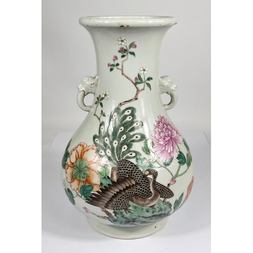 540 - A Chinese famille rose vase decorated with polychrome peacock and flowers, with elephant handles, ht... 