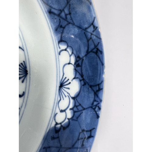 542A - A Chinese Kangxi blue and white plate with floral decoration, leaf mark under, diameter 21cm (minor ... 