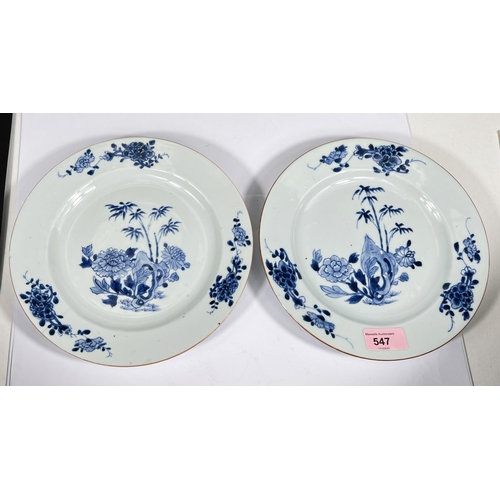 547 - An 18th century Chinese pair of plates decorated with trees and plants, diameter 23cm