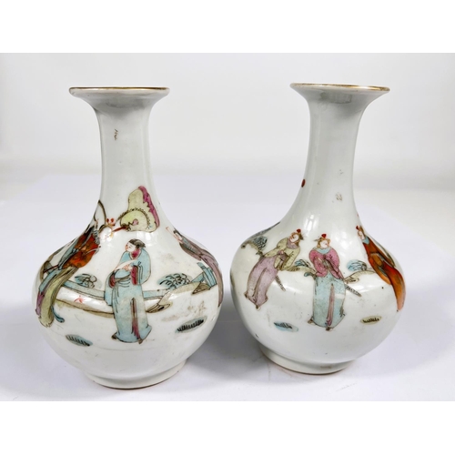 551 - A pair of 18th/19th century Chinese famille rose vases decorated with people in robes, gilt rim, ht.... 