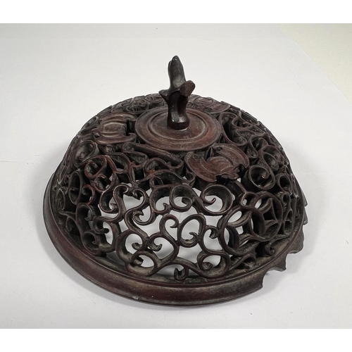 552 - A Chinese extensively carved and pierced wooden pot lid decorated with bats etc, dia. 14cm