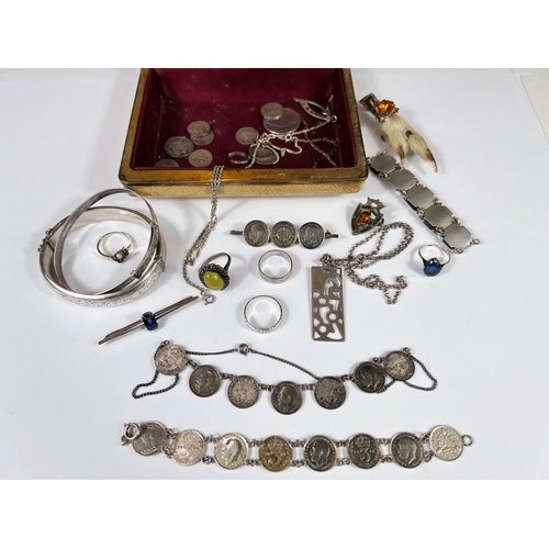 606 - A hallmarked silver bangle; an engine turned bracelet; a Scottish white metal paw brooch set blue st... 