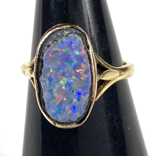 609 - An 18ct gold oval shaped black opal (14mm x 9mm) doublet ring, 3.37gms, ring size K/L.