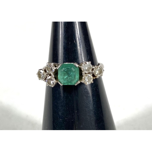 611 - A platinum stamped Art Deco dress ring, square cut emerald approximately 6mm x 6mm with bevelled and... 