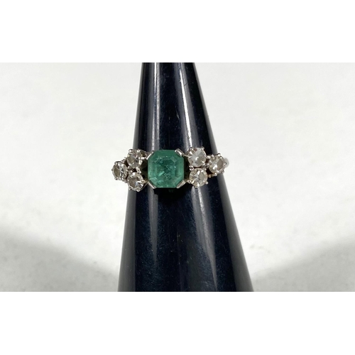 611 - A platinum stamped Art Deco dress ring, square cut emerald approximately 6mm x 6mm with bevelled and... 