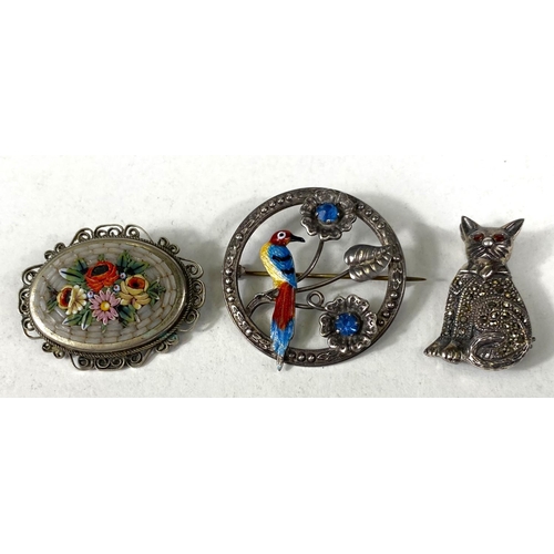 613 - A sterling silver brooch with enamelled bird in flowers, set 2 blue tones; a white metal brooch stam... 