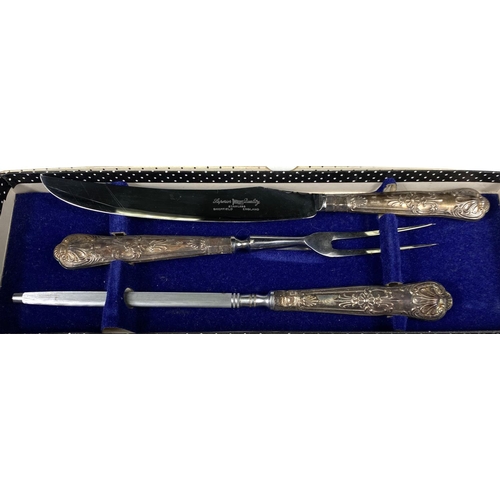 621 - A silver handled boxed carving set, four cased silver plated buckle napkin rings; a cased set of hal... 