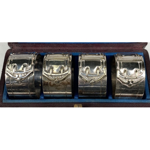 621 - A silver handled boxed carving set, four cased silver plated buckle napkin rings; a cased set of hal... 