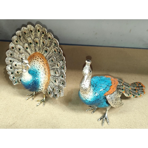 65 - Two silvered metal peacocks with enamelled decoration  