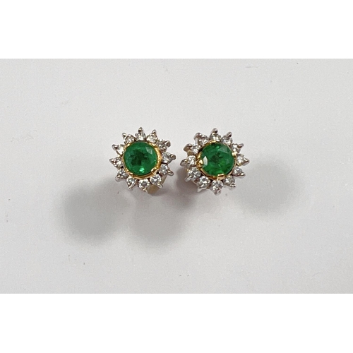 662 - A pair of 18ct white and yellow gold earrings set with central emerald approx 4mm surrounded by smal... 