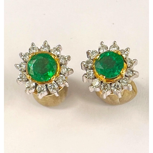 662 - A pair of 18ct white and yellow gold earrings set with central emerald approx 4mm surrounded by smal... 