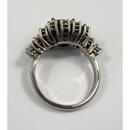 663 - An Art Deco style 18ct white metal dress ring set with large central emerald. 8 x 6mm approx surroun... 