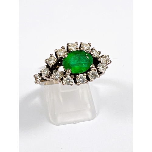 663 - An Art Deco style 18ct white metal dress ring set with large central emerald. 8 x 6mm approx surroun... 