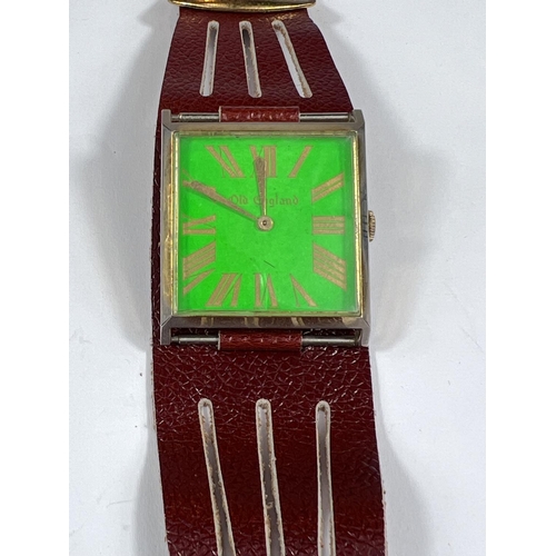 695 - A 1960s old English large dial pilot style wristwatch with square face green background gilt case an... 