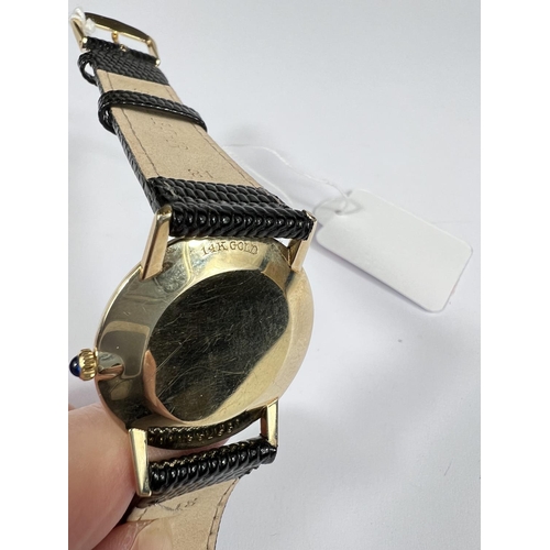 696 - UNIVERSAL GENEVE: a c.1960 gold Swiss watch with gold dial, black hands and black/gold batons, blue ... 