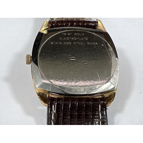 697 - A gentleman's gilt cased Universal Geneve 'Guilt Shadow' wristwatch with Batten numerals square face... 