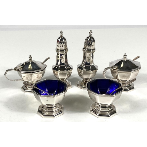 715 - A hallmarked silver 6 piece cruet of octagonal form on raised feet, with blue glass liners, Sheffiel... 