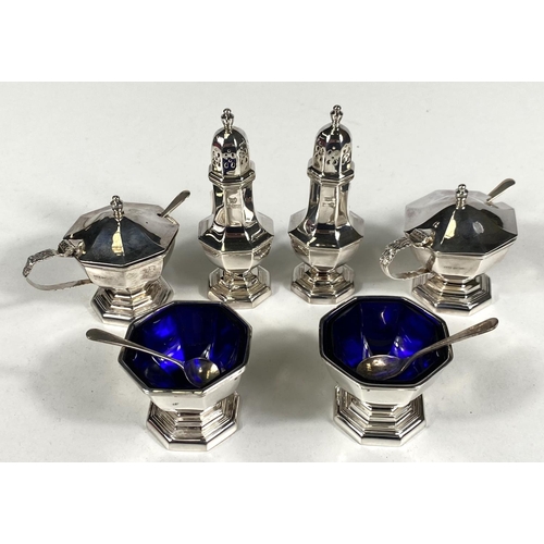 715 - A hallmarked silver 6 piece cruet of octagonal form on raised feet, with blue glass liners, Sheffiel... 