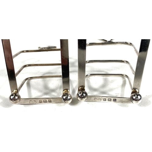 716 - A hallmarked silver pair of 4 division toast racks, Birmingham 1927, 2.5oz