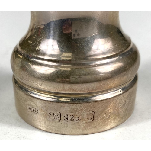 719 - A hallmarked silver pair of pepper grinders, London, date marks worn