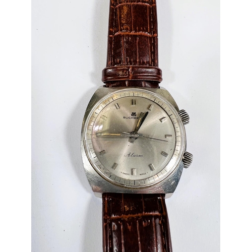 747 - A mid 20th century gents Bucherer Alarm gents wristwatch with silvered dial, steel case alarm compli... 