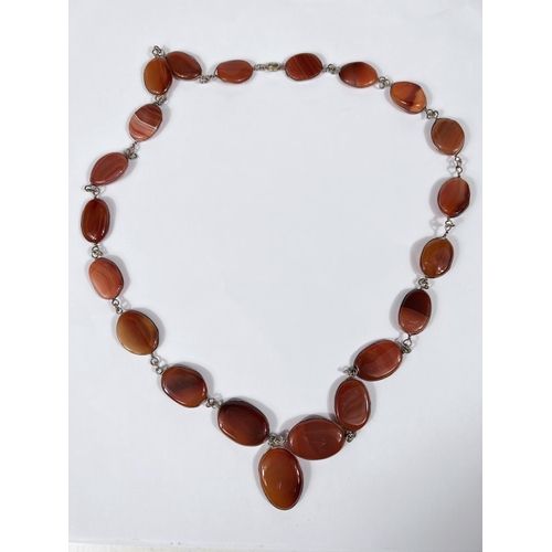 761 - A silver and agate necklace with oval shaped beads and lace silvers surrounds (internal circumferenc... 