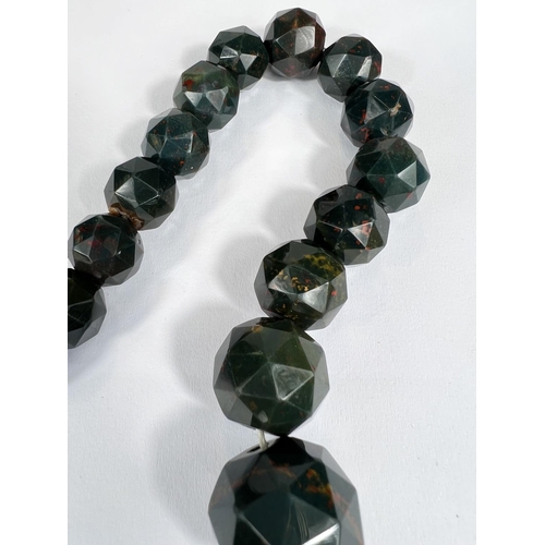 763 - A graduating Faceted Spherical bead Heliotrope (bloodstone) necklace with yellow metal clasp