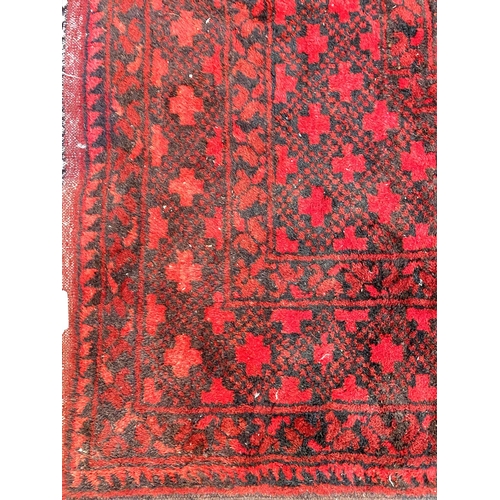 834 - An Afghan carpet 360 x 306 cm