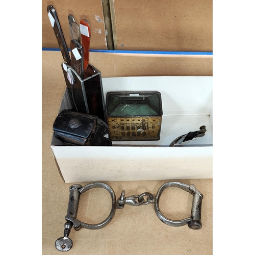 85 - A pair of handcuffs; a pair of spurs; an old bicycle lamp; etc.