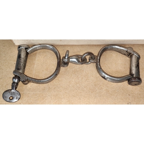 85 - A pair of handcuffs; a pair of spurs; an old bicycle lamp; etc.