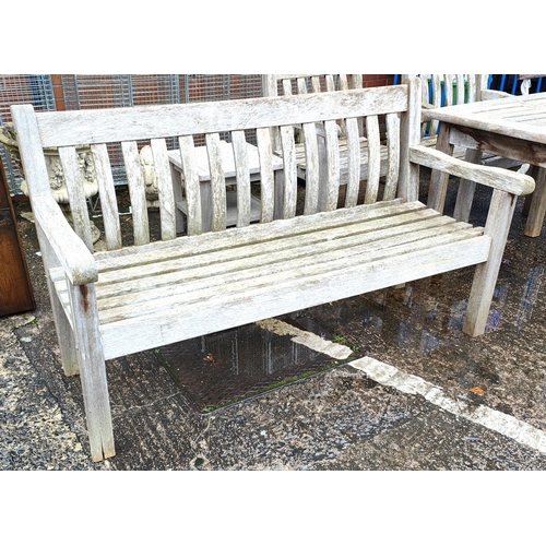 853 - A teak garden bench and side table 