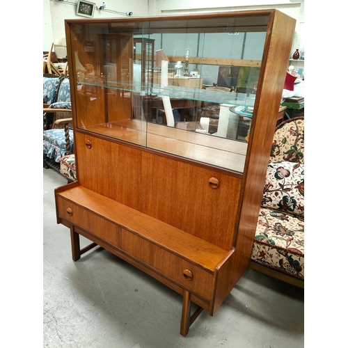 864 - A mid century teak wall unit with sliding glass doors above, cocktail section below and two draws&nb... 