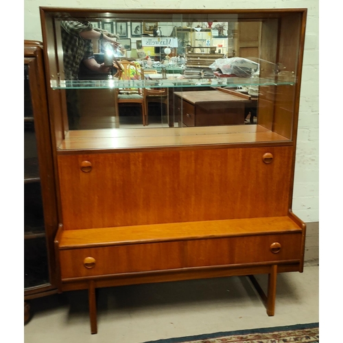 864 - A mid century teak wall unit with sliding glass doors above, cocktail section below and two draws&nb... 