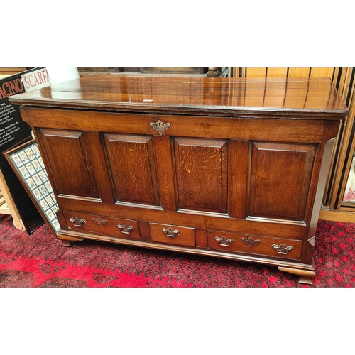 871 - An 18th century oak mule chest with panelled front Three draws below hinged lid. 142 x 87 x 58cm